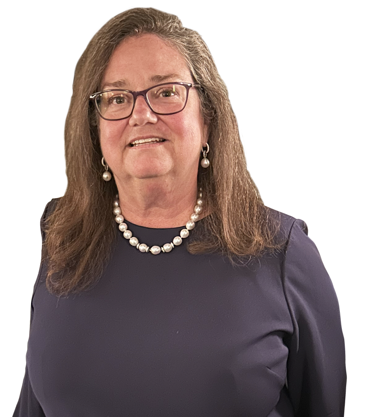 A woman with long brown hair and glasses wearing a dark top and pearl necklace smiles at the camera.