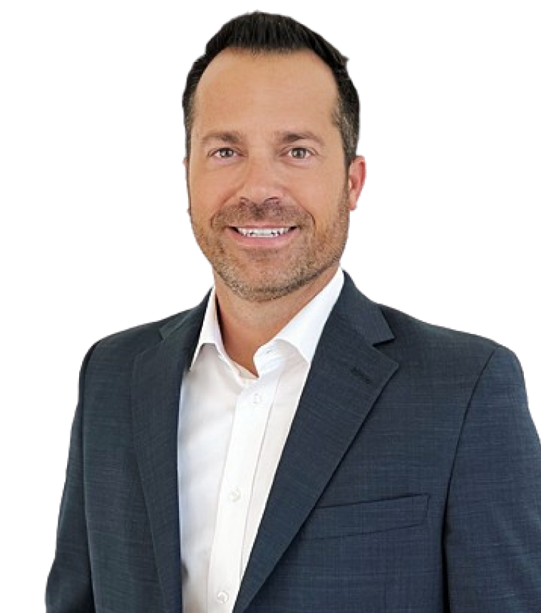 Man in a dark suit with a white shirt, smiling, against a plain background.