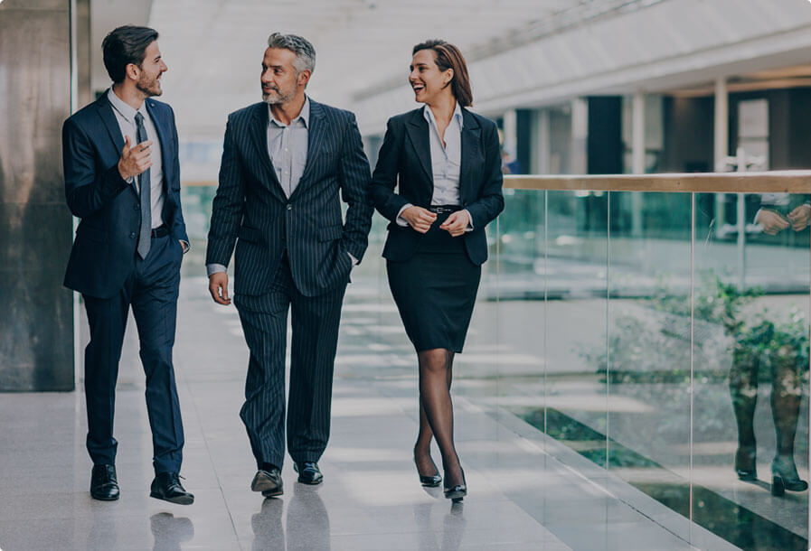 A group of business people walking in an office building.