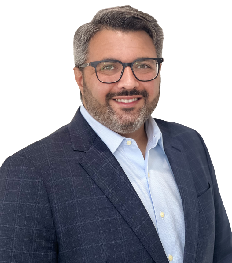 Man with gray hair and a beard, wearing glasses and a blue suit, smiling against a white background.